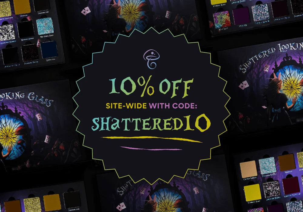 Dark-themed promotional image featuring makeup palettes with vibrant colors. Text in center reads "10% Off Site-wide with Code: SHATTERED10." Enchanting, mystical vibe.